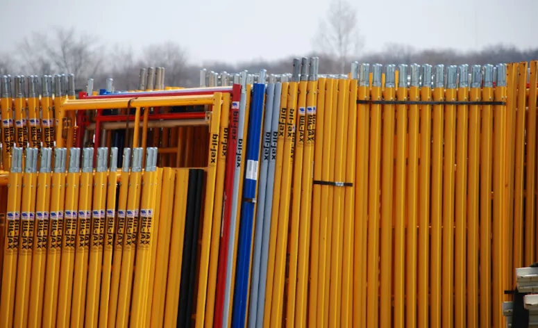 Bil-Jax scaffolding frames organized in yard