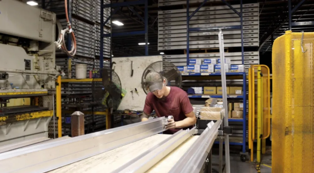 A worker checks the metal scaffolding before inspection.